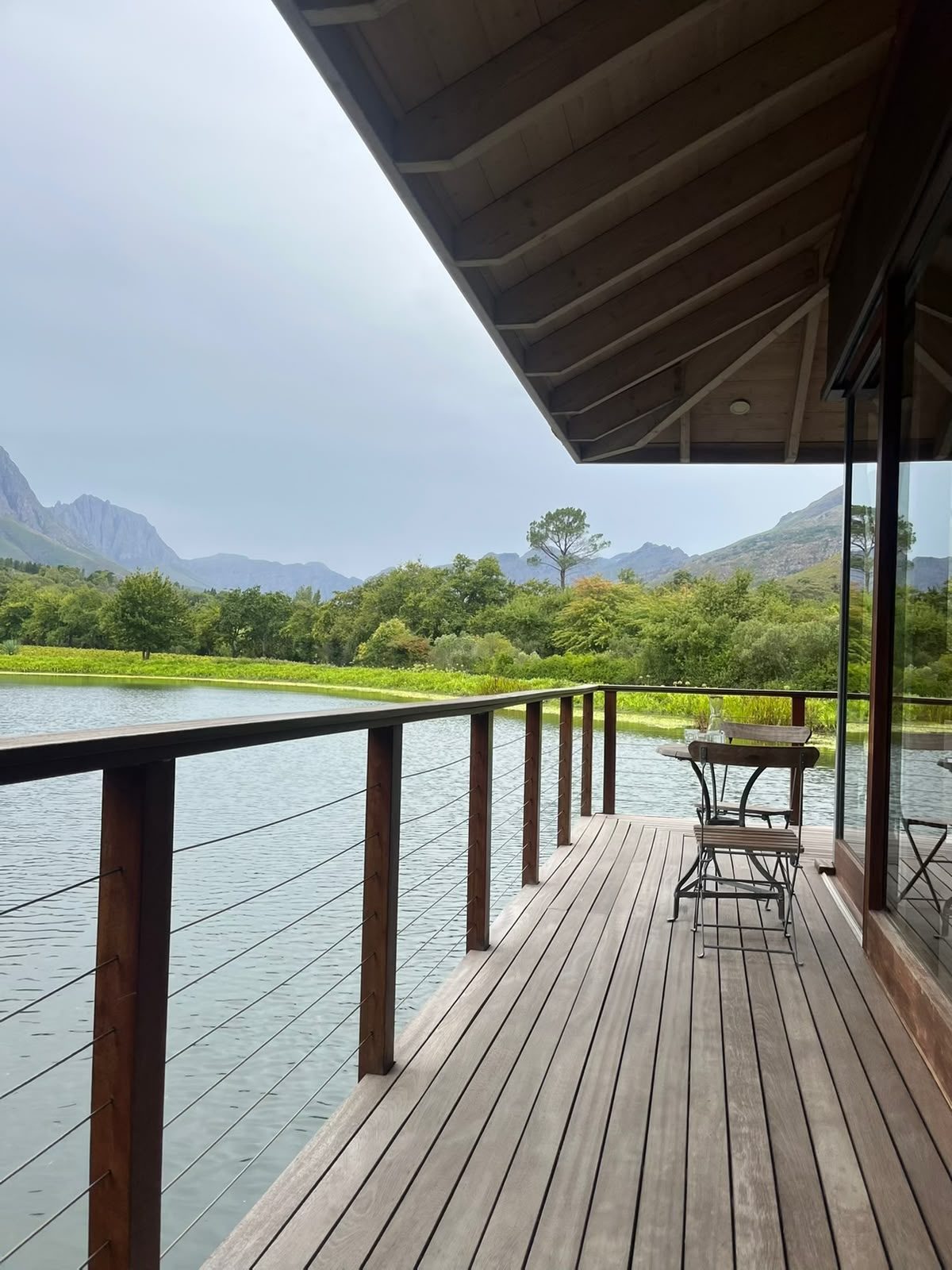 Deck overlooking a farm dam and mountains at Boschendal in the Cape Winelands